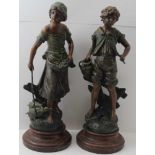 AFTER MOREAU A PAIR OF FRENCH SPELTER FIGURES, a country boy & girl, bronzed effect on turned wood