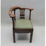 A GEORGIAN MAHOGANY CORNER CHAIR having horseshoe back with turned columns and pierced slats, with