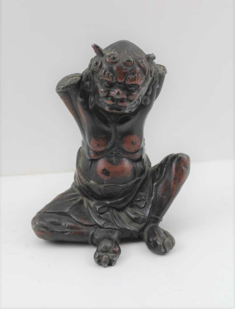A JAPANESE MEIJI PERIOD CAST LEAD SEATED DEMON or DEVIL bronzed patinated, 12cm high