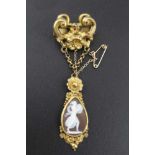 A VICTORIAN BROOCH, having gilt metal frame with chains suspending a tear drop form shell cameo,