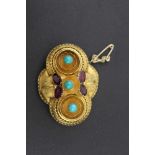 A VICTORIAN BROOCH in the Etruscan taste, inset with a cut amethyst and turquoise