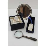 A SILVER-HANDLED MAGNIFYING GLASS, a SILVER NOTE CLIP (cased), a SILVER BOOKMARK (cased) and a