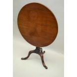 A MID VICTORIAN MAHOGANY OCCASIONAL TABLE, the circular top on turned pedestal, on triform