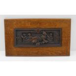 A BRONZED COPPER PANEL, reclining classical figure with books and putti in the manner of