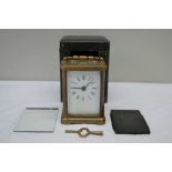 A SMALL BRASS & GLASS CASED CARRIAGE TIMEPIECE, of typical form and construction, displayed in an