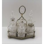 A VICTORIAN SILVER-PLATED SIX BOTTLE CONDIMENT STAND, the bottles with facet cut necks and cut glass