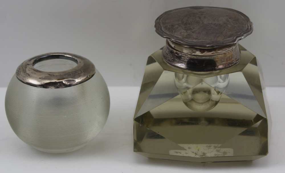 A FACET CUT DESK INKWELL with silver, hinged cover and decorative pie-crust rim, Birmingham 1909,