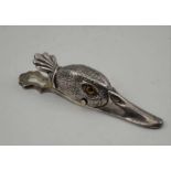 A PLATED CLIP IN THE FORM OF A DUCK'S HEAD, inset glass eyes, 12.5cm