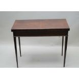 A 19TH CENTURY GRAINED MAHOGANY FOLDOVER BAIZE LINED CARD TABLE, the interior satinwood crossbanded,