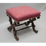 A 19TH CENTURY ROSEWOOD FRAMED PAD TOP STOOL with scrolling 'X' shaped supports united by a double
