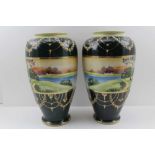 A PAIR OF 20TH CENTURY JAPANESE PORCELAIN VASES banded with hand painted river landscapes in the