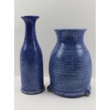 TWO STUDIO POTTERY VASES, blue glaze, one of bottle form, 25cm high, the other raised upon three lug