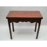 A GEORGE III MAHOGANY TEA TABLE , the rectangular top over a cross grained shaped frieze, on four