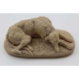 A VICTORIAN SOAPSTONE RECLINING HOUND, base 15cm