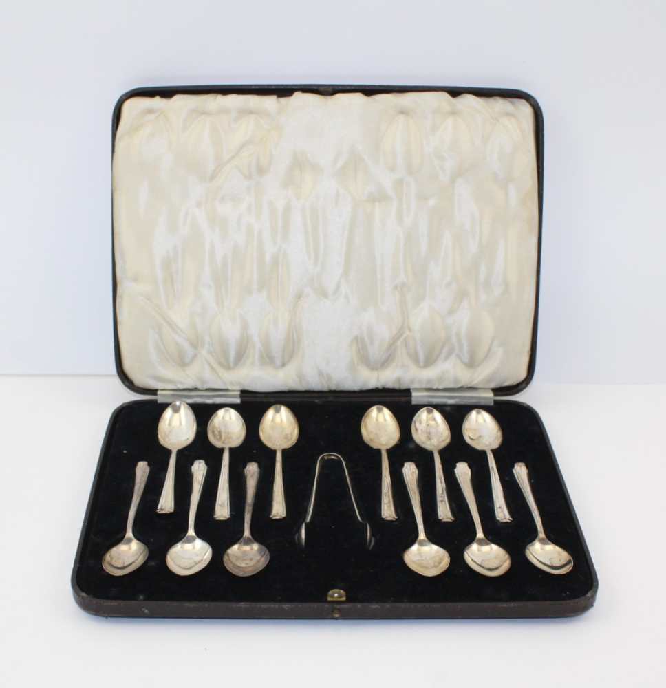 HENRY ATKIN A SET OF TWELVE SILVER TEASPOONS, Sheffield 1937 together with a pair of silver sugar