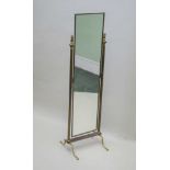 A BRASS FRAMED CHEVAL DRESSING MIRROR, fluted column supports with brass cast lion finial, 136.5cm