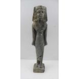 A CARVED SOAPSTONE STANDING EGYPTIAN FIGURE, Royal depiction wearing Nemes with lappets, a series of