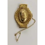 A VICTORIAN GOLD BROOCH of Etruscan form, the raised oval centre on a starburst oval panel with