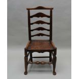 A 19TH CENTURY COUNTRY MADE LADDER BACK CHAIR with solid seat, 98cm high