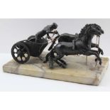 A LATE 19TH CENTURY BRONZE ROMAN CHARIOTEER driving two rearing horses, raised upon a veined