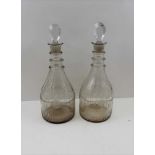 A PAIR OF GEORGE III CLEAR GLASS MALLET FORM DECANTERS, with triple ring necks, fluted bases and