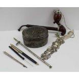 AN OVAL PIQUE WARE BOX & COVER, 9cm, together with; a silvered letter opener cast with a mermaid