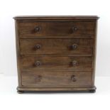 A LATE 19TH CENTURY MAHOGANY COLLECTOR'S CHEST OF FOUR DRAWERS, with turned knob handles, raised