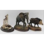 THREE PAINTED RESIN WILD ANIMALS, to include; a 'Country Artists' Bull elephant, a wolf on a