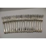 A MATCHED SET OF EIGHTEEN 19TH CENTURY SILVER DESSERT FORKS, fiddle & shell handles some crested, to