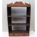 A 19TH CENTURY MAHOGANY WALL RACK, fret cut crest fitted shelves and two drawers to base, 54cm x