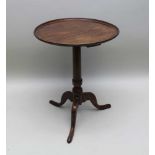 A 19TH CENTURY MAHOGANY SAUCER TOP WINE TABLE, on turned stem and tripod supports, 51cm in diameter
