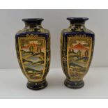 A PAIR OF JAPANESE SATSUMA VASES, blue ground, painted and gilded with panels of figures and