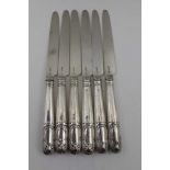 A SET OF SIX GEORGE III SILVER BLADED DESSERT KNIVES, shell decorated handles, London 1806, possibly