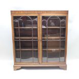 A FIRST QUARTER 20TH CENTURY MAHOGANY FINISHED FREESTANDING BOOKCASE, with twin fancy bar glazed