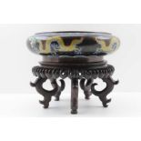 A CHINESE CLOISONNE BOWL, black ground decorated with yellow five toe dragons chasing 'the pearl