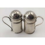 TWO LATE 19TH CENTURY SILVER KITCHEN BUN PEPPER POTS with handles, Birmingham 1897 (different