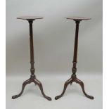 A PAIR OF GEORGIAN DESIGN MAHOGANY TORCHERES, octagonal tops on stems with tripod bases, 96cm high