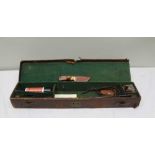 A LATE VICTORIAN / EDWARDIAN LEATHER GUN CASE 80cm x 17cm, and contents, includes cleaning rods, '