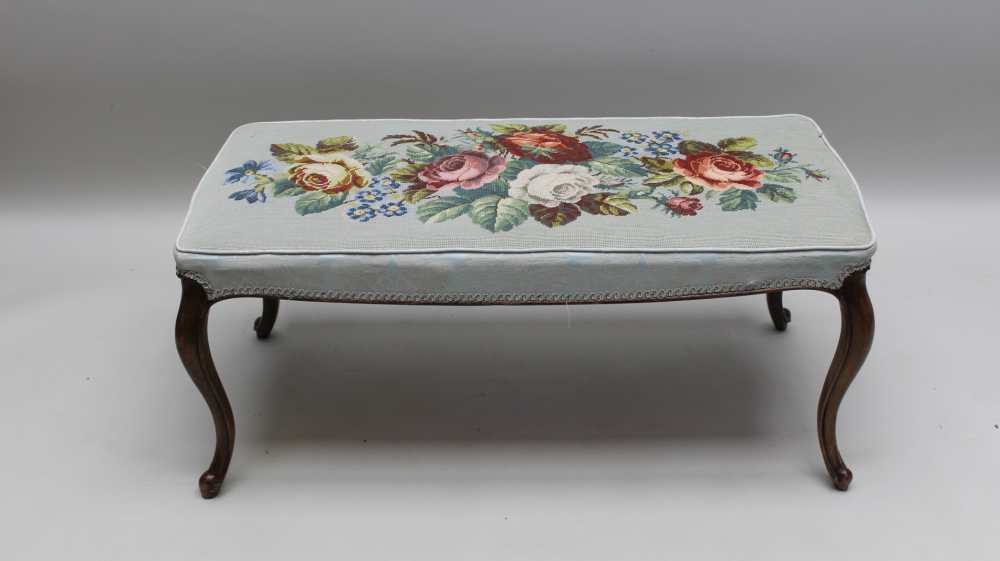 A GEORGIAN DESIGN DOUBLE STOOL having woolwork upholstered seat of floral design, raised on