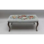 A GEORGIAN DESIGN DOUBLE STOOL having woolwork upholstered seat of floral design, raised on