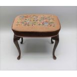 A GEORGIAN DESIGN STOOL, on mahogany cabriole legs, woolwork upholstered top, 56cm x 43cm