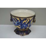 A CONTINENTAL POTTERY JARDINIERE PLANTER, blue floral and gilded decoration, 21cm high
