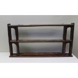 A 19TH CENTURY OAK WALL SHELF RACK with two moulded niches to the ends, 118cm wide x 61cm high