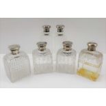 A PAIR OF SILVER CAPPED SQUARE FORM PLAIN GLASS PERFUME BOTTLES, London 1929, another pair of