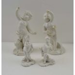 TWO PAIRS OF GERMAN PORCELAIN PUTTI FIGURES, in the white, the tallest pair 16cm high, the smaller
