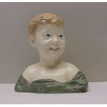 A CONTINENTAL POTTERY BUST OF A CHILD, 29cm high, (factory mark inside)