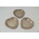 A PAIR OF SILVER HEART SHAPED PIN DISHES, 7.5cm together with one other similar, late 20th century