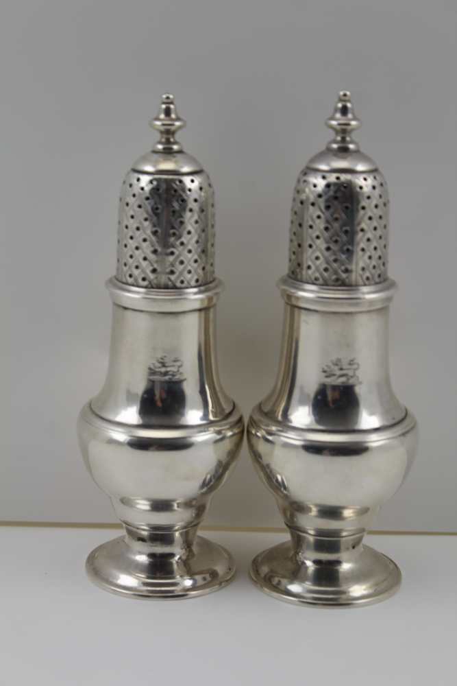 A PAIR OF GEORGIAN DESIGN SILVER SUGAR SIFTERS of baluster form, raised on domed bases, engraved