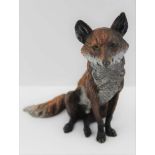 A 20TH CENTURY AUSTRIAN COLD PAINTED BRONZE SEATED FOX, impressed 'Austria' to the base, 13.5cm high