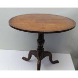 A 19TH CENTURY OAK SNAP-TOP SUPPER TABLE, on turned stem and triform supports